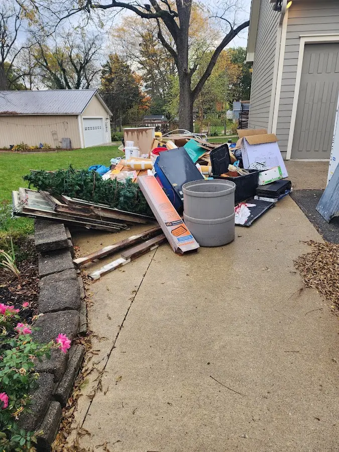 Dumpster being loaded with debris for 3 Yard Dumpster Rental in Itasca